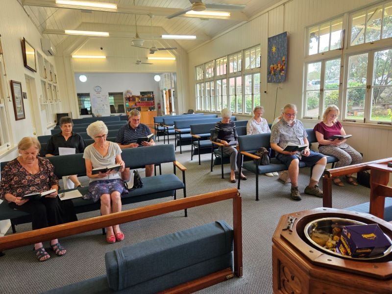 People in a light-filled church praying Morning Prayer 