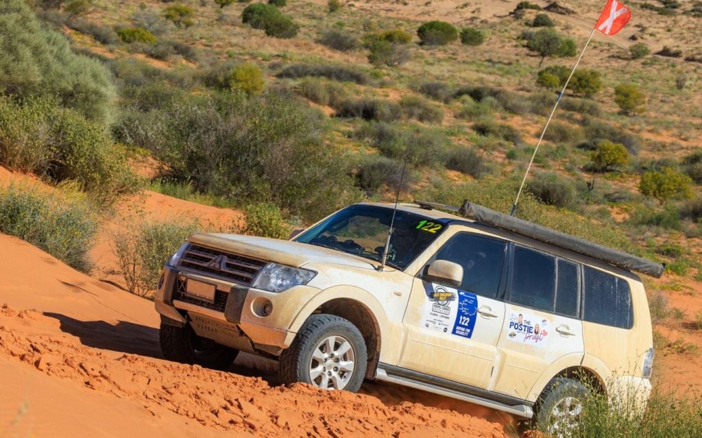 White Mitsubishi driving in an Outback rally