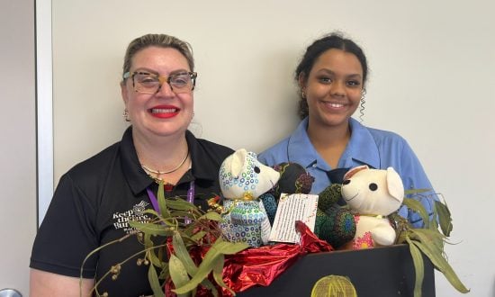 Woman and girl in a hospital with teddy bears featuring Aboriginal designs