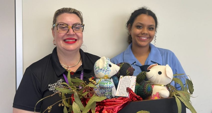 Woman and girl in a hospital with teddy bears featuring Aboriginal designs