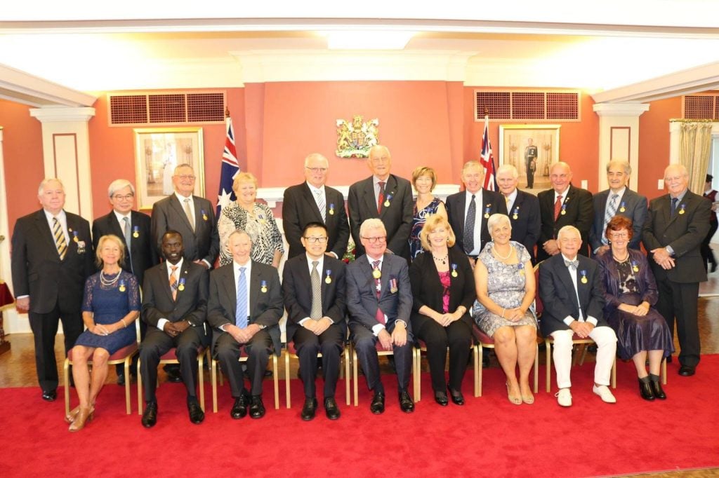 A group of award recipients sitting with the Queensland Governor at Government House 