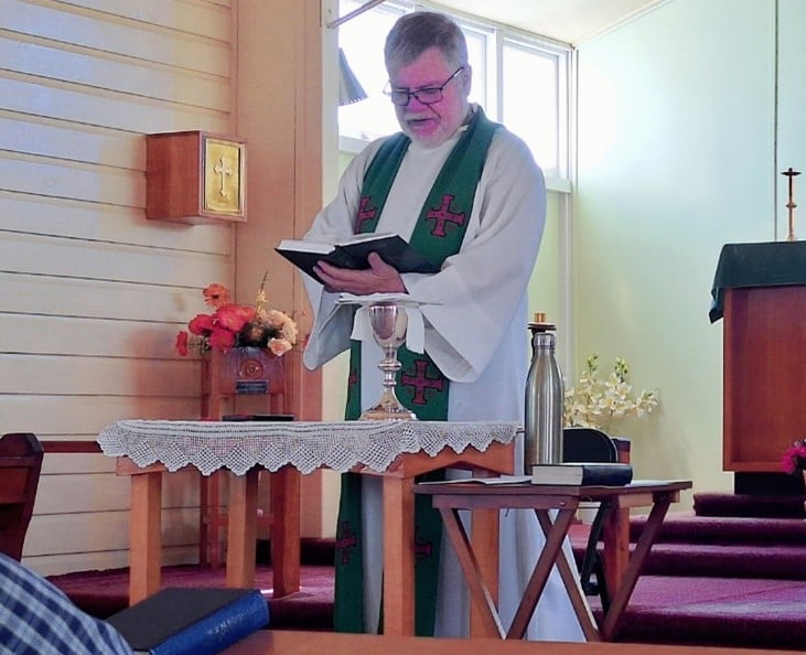 A priest in robes during a service 