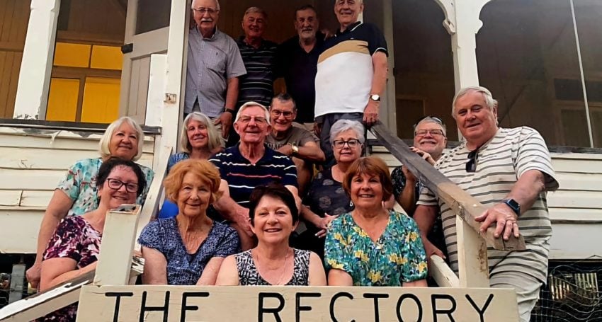 Group of people in front of an outback rectory