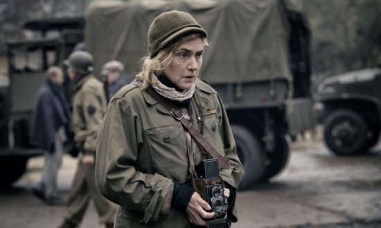 Woman war photographer holding a camera