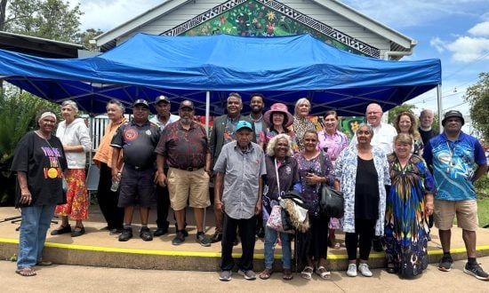 Senior priests and elders outside a ration shed museum