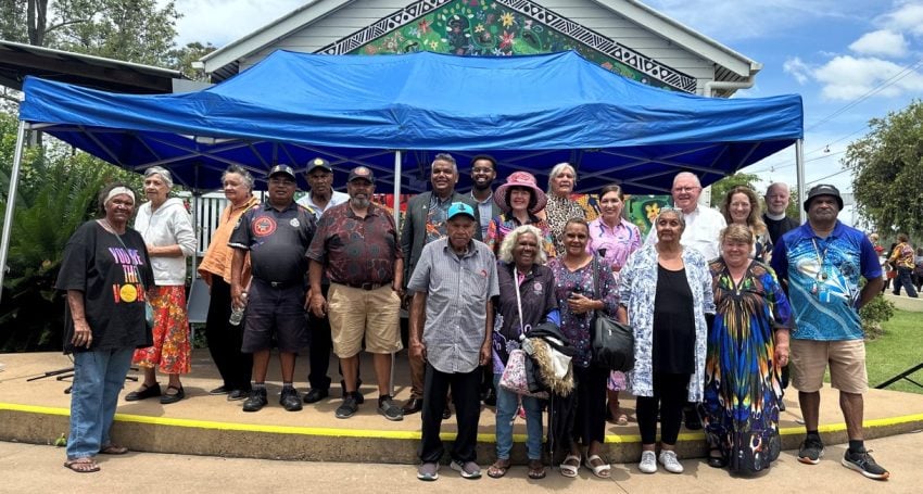 Senior priests and elders outside a ration shed museum