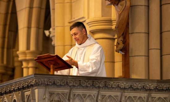 Priest in white robes in a pulpit