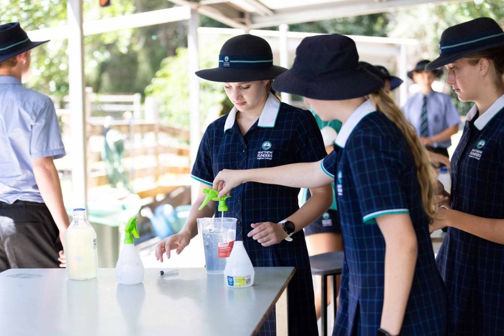 School students testing water at a farm 