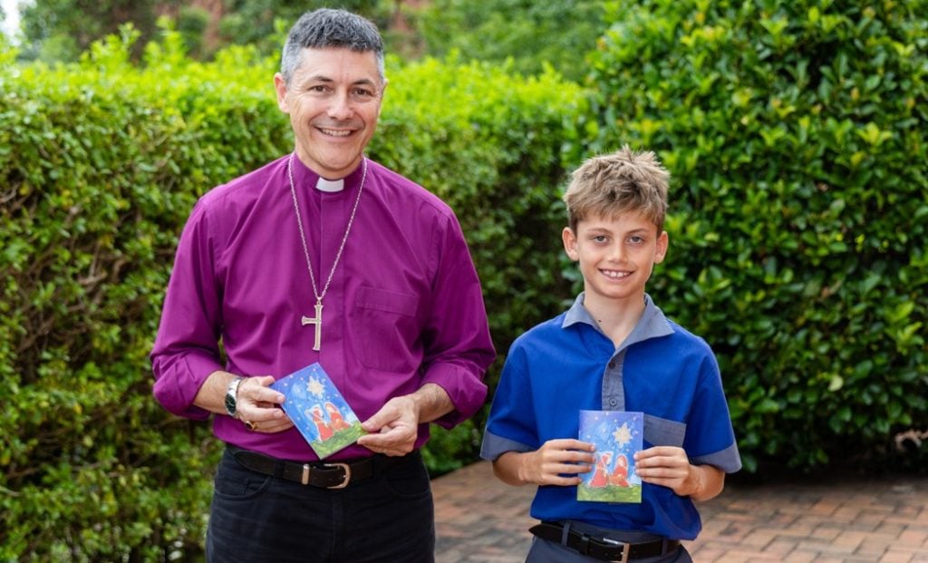 Archbishop in purple shirt with a school boy 