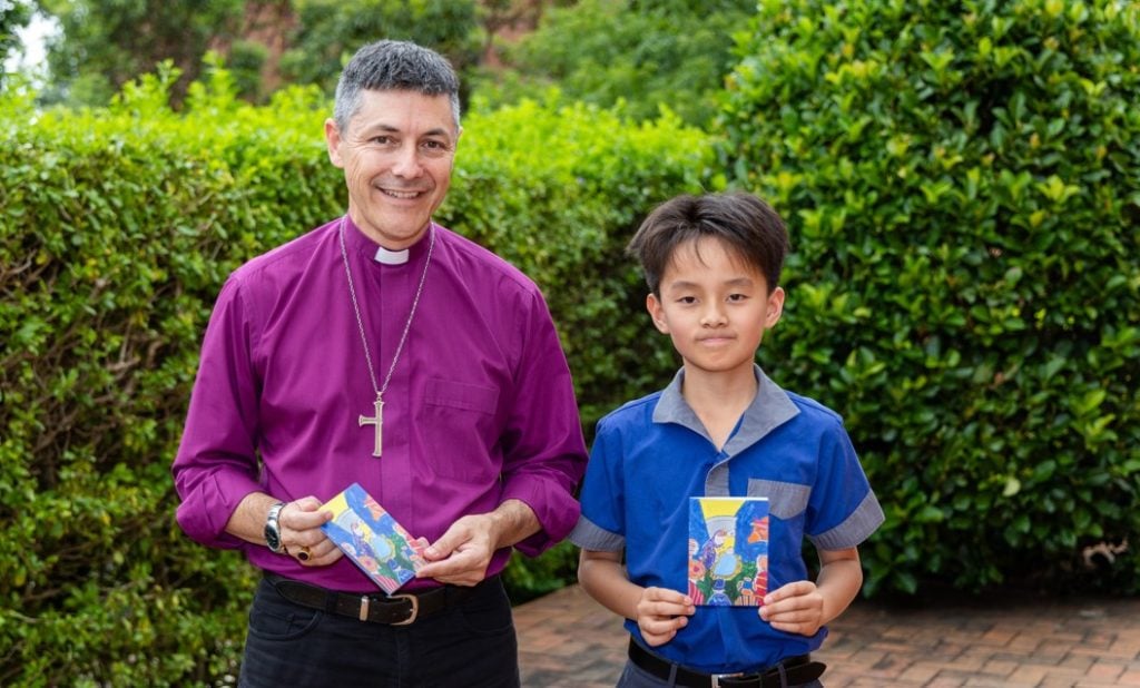 Archbishop in purple shirt with a school boy