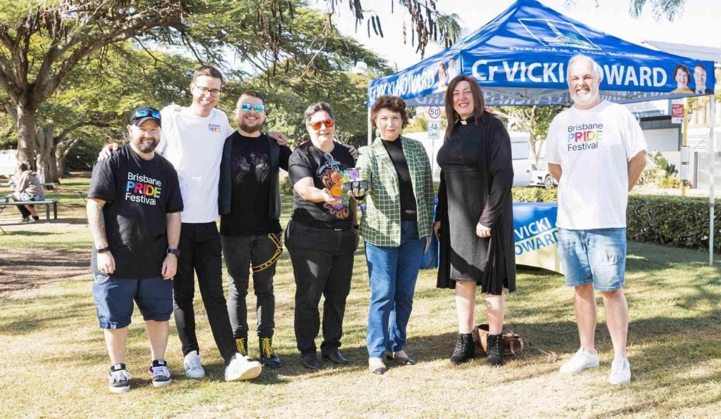 A group of LGBTIQA+ people and their allies in a park 