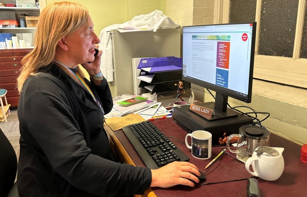 Woman priest on the pone in her office 