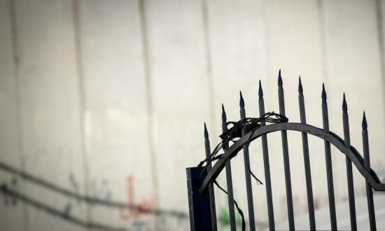 Barbed wire in front of white wall