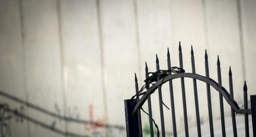 Barbed wire in front of white wall