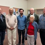 Group of people in a church hall smiling at the camera