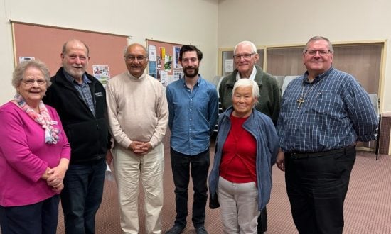 Group of people in a church hall smiling at the camera