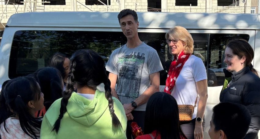 Bishop Sarah Plowman, husband Darius Cartwright, and Rev’d Juliana Bate chat with students at All Saints Mission Incorporated School