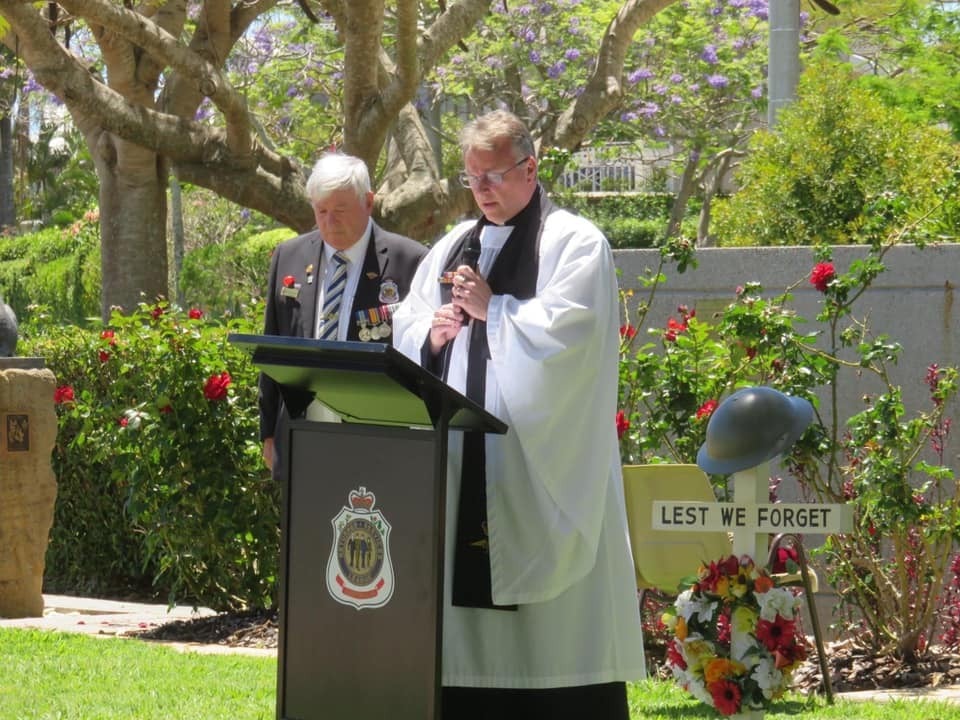 Priest leading a Remembrance Day service outside
