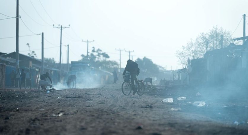 Micha town in Oromia, Ethiopia. Dust and smoke fills the air, as night fires are dying out, lit by people who sleep on the streets.