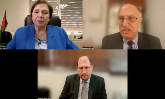 A screenshot of three panelists seated in their offices, engaged in discussion