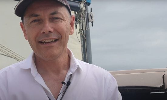 Man in cap and white shirt on a boat