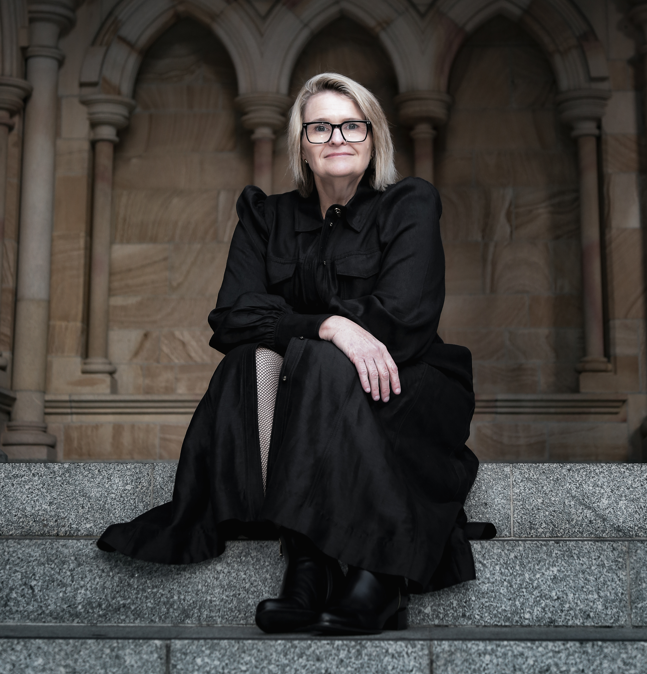 A woman poses for a photograph in front of the Cathedral