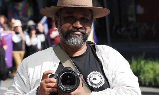 Man in Akubra hat holding a camera