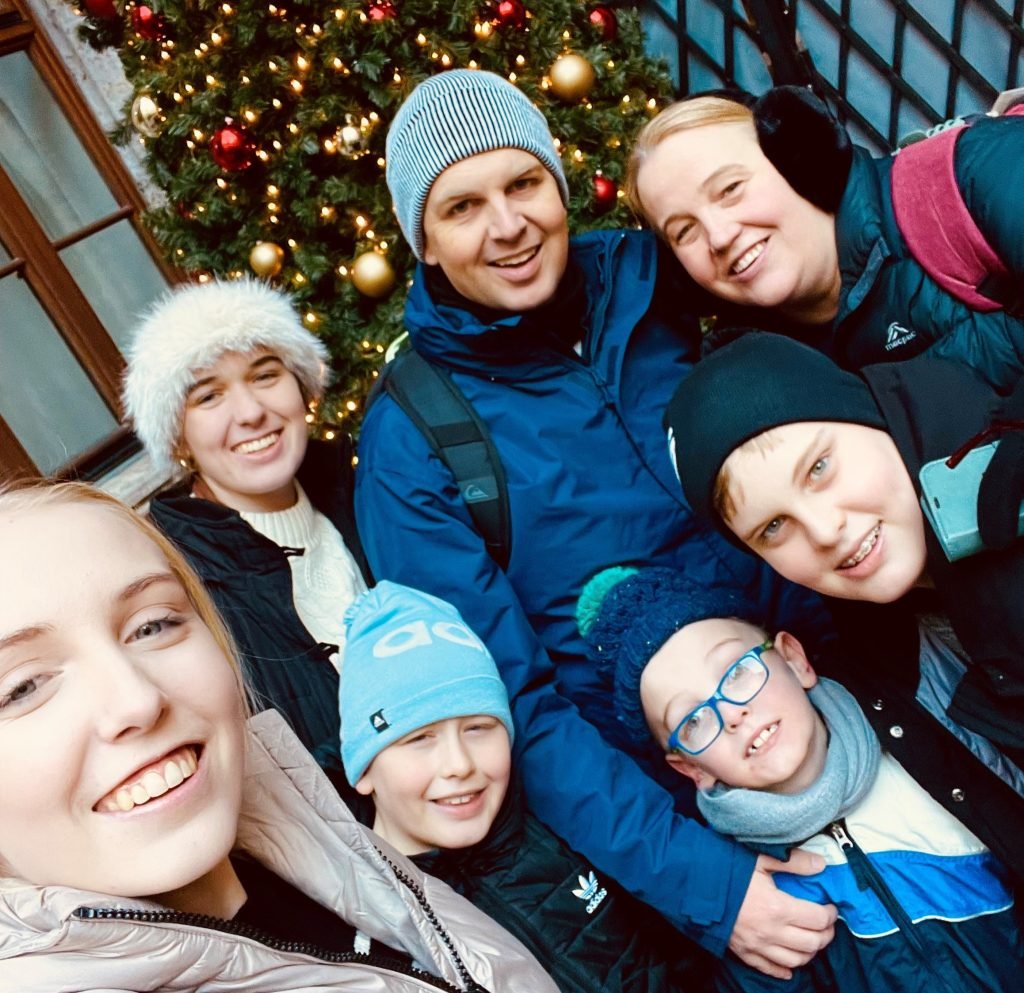 Two parents and five kids wearing ski gear