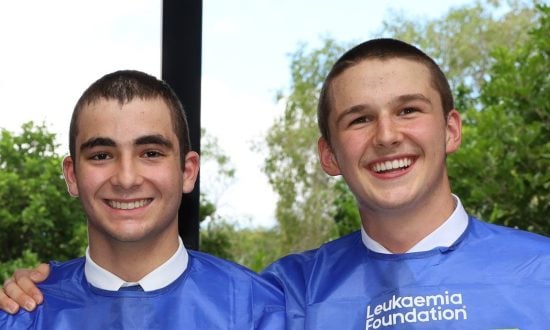 Two Churchie students pose for a photo with shaved heads