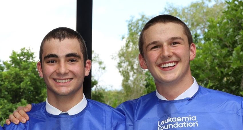 Two Churchie students pose for a photo with shaved heads