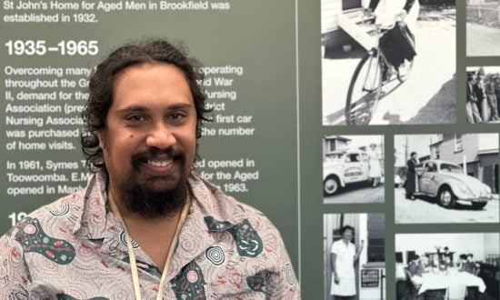 Man standing in front of photo mural