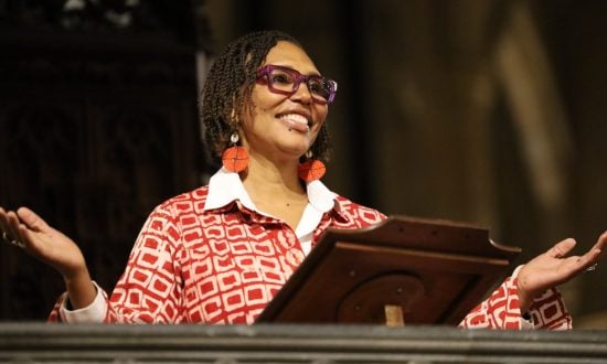 Image of a woman preaching from a pulpit