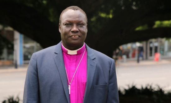 Arican bishop in purple shirt and collar