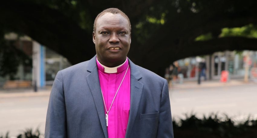 Arican bishop in purple shirt and collar