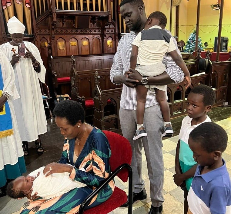African family celebrating the blessing of a baby