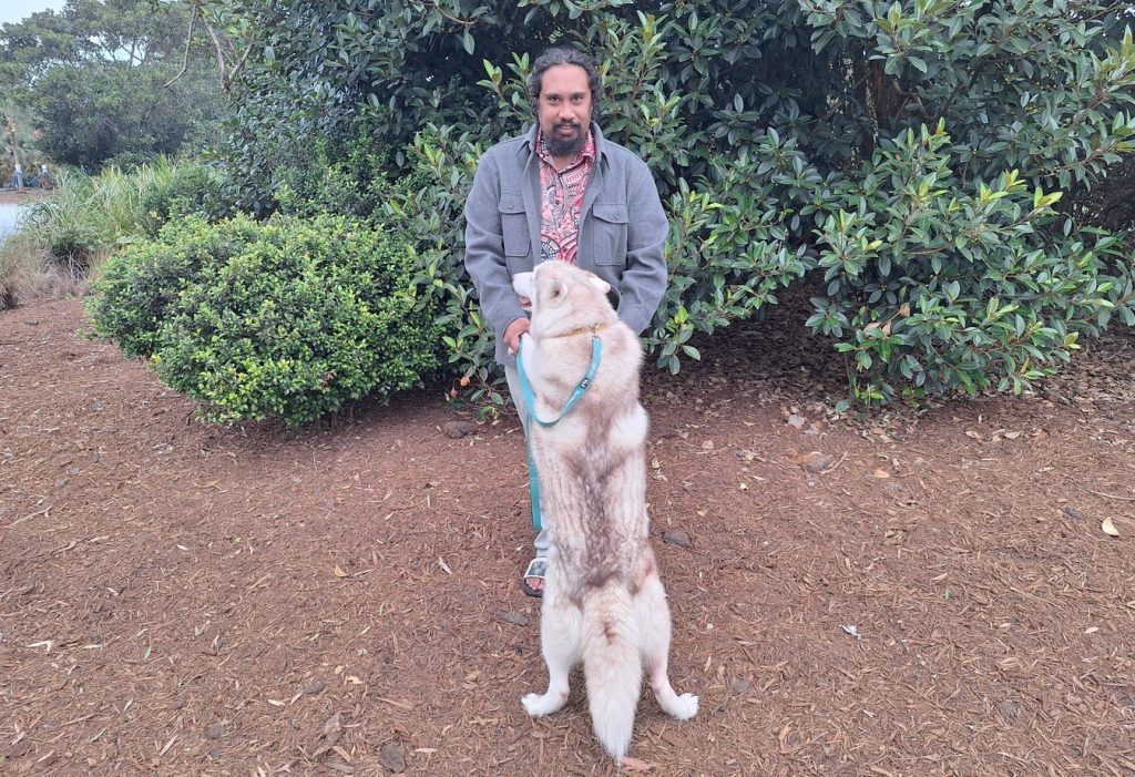 Man with a husky dog in the bush