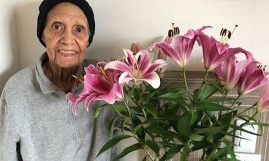 Aboriginal elder with pink lilies