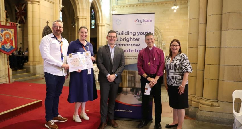 A group of people pose for a photo in St John's Cathedral for the Fishes and Loaves luncheon
