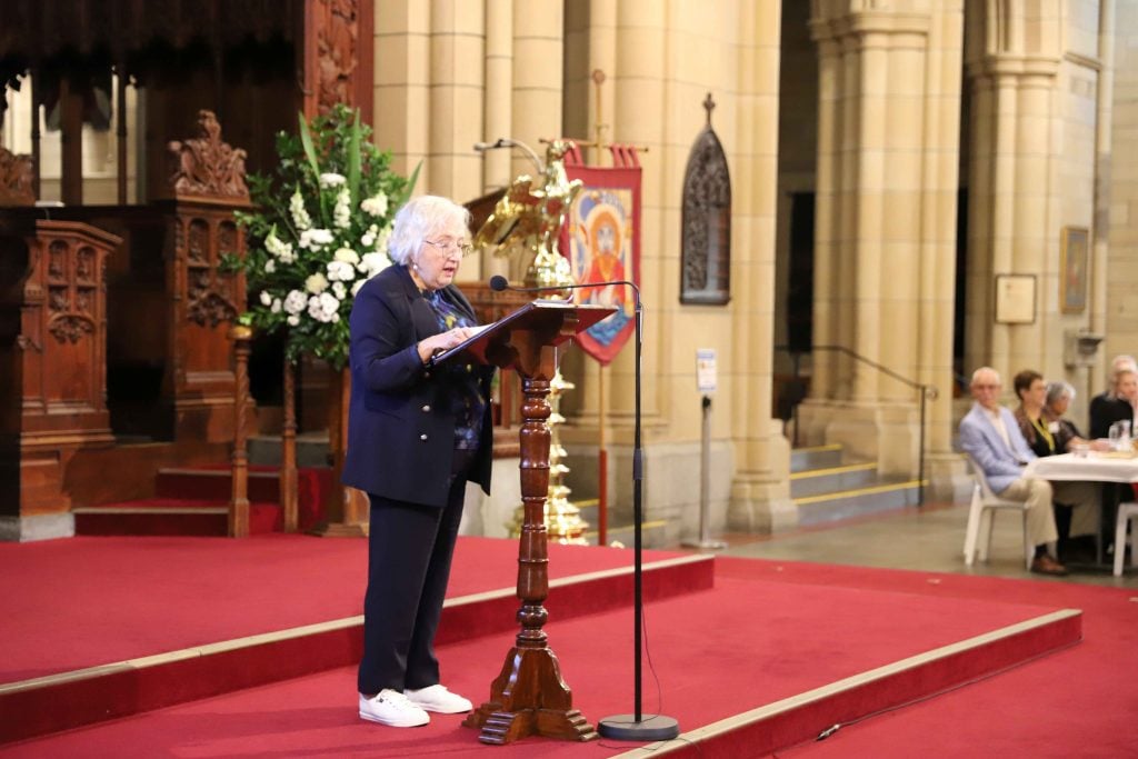A woman addresses a crowd in St John's Cathedral