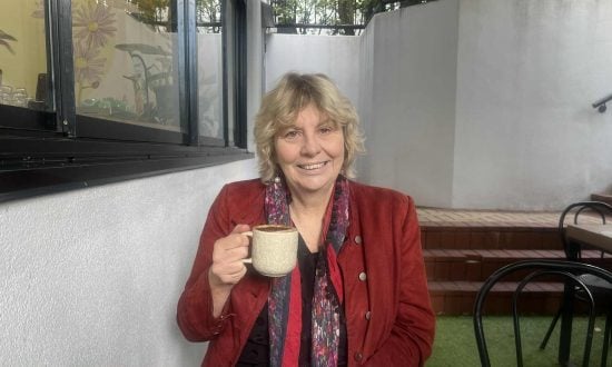 Woman in red jacket drinking a coffee