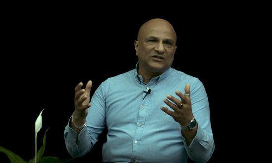 A man in a studio talks to the camera