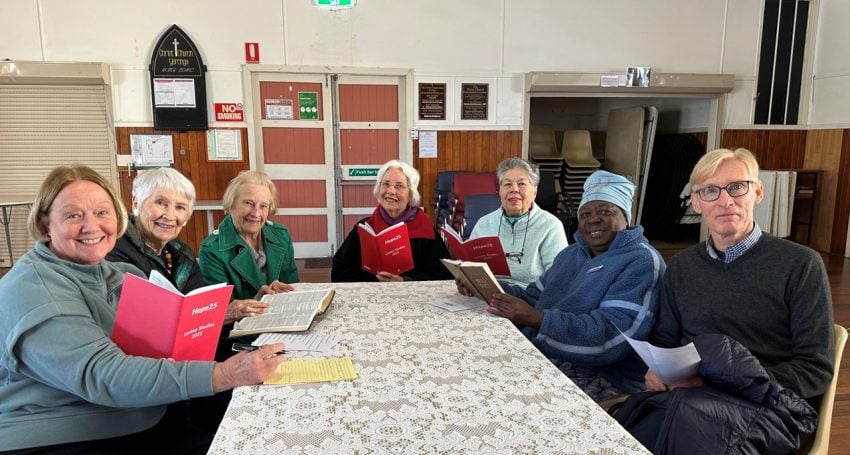 Group of people in a church hall doing a Bible study
