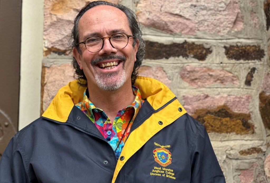 Man in navy jacket and colourful shirt 