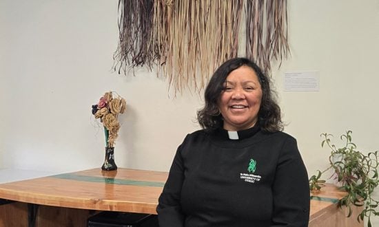 Māori priest in her office