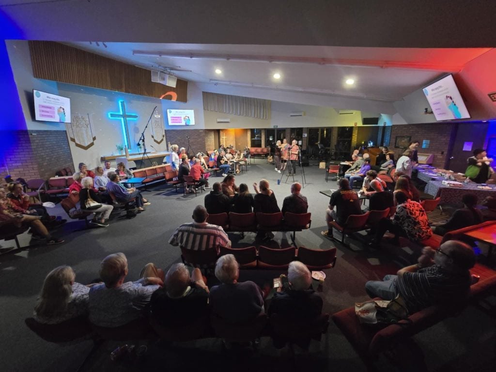 People enjoying live music in a church hall
