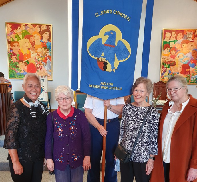 Women in a church with a banner