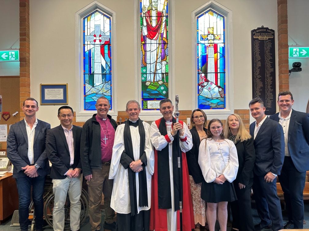 Group of people under a stained-glass window 