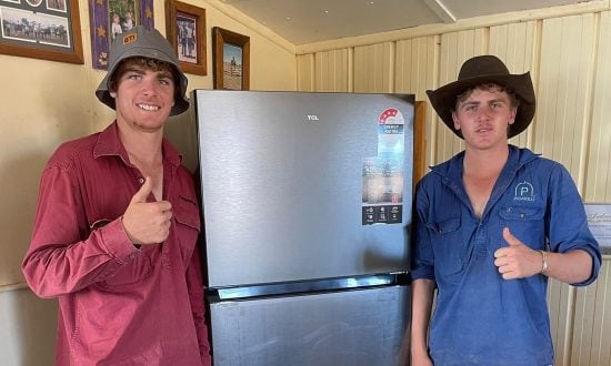 Two teenage boys stand in front of a fridge for a photo to promote the campaign
