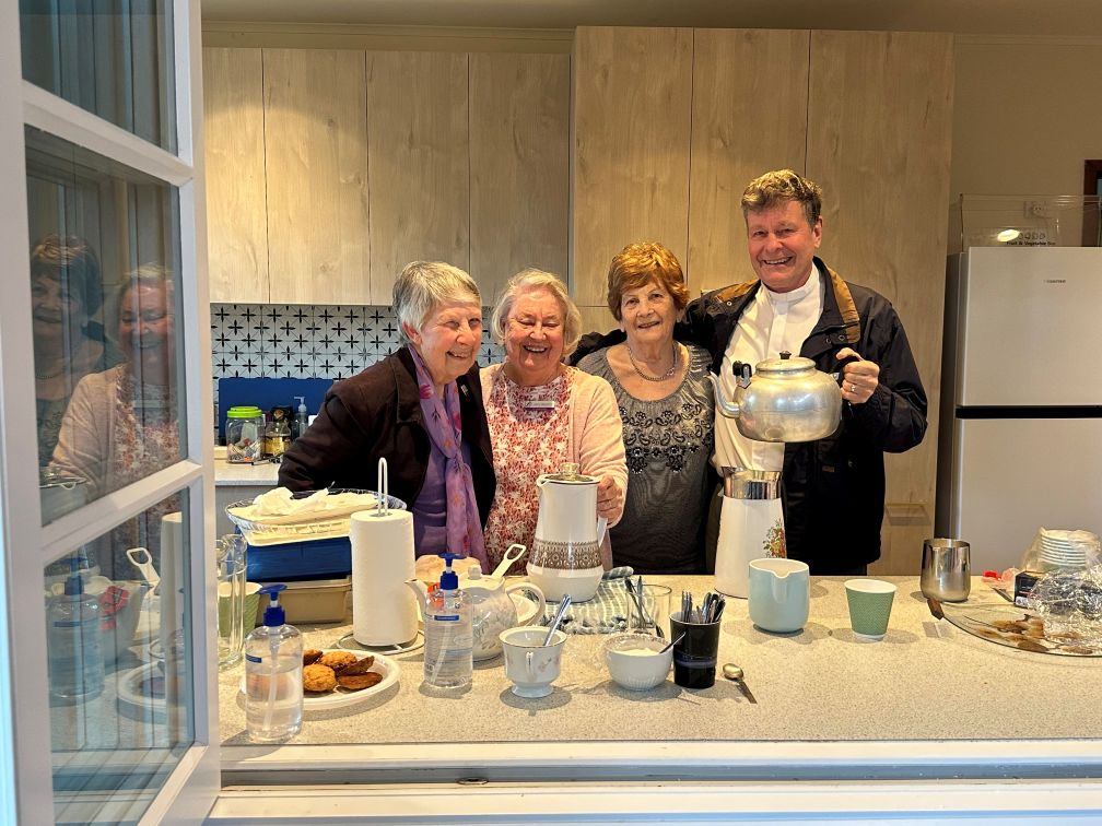 people in a church kitchen serving tea and coffee