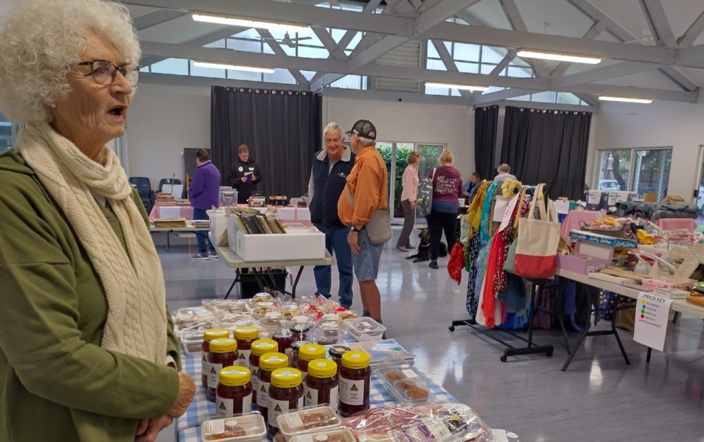 Woman selling food items at an indoor market